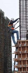 Image of Rebar Installer climbing a column of steel rods